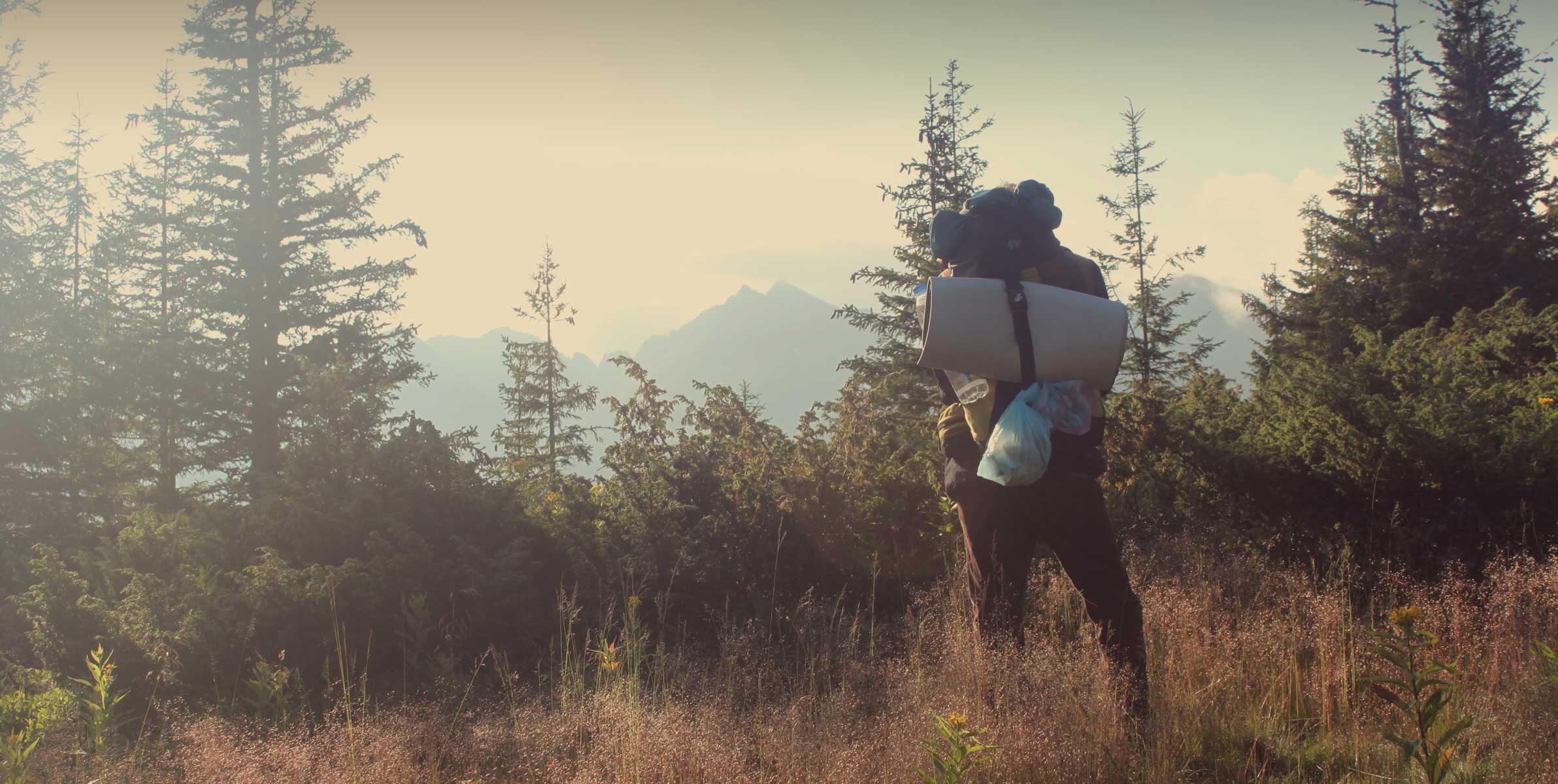 Hiker with sleeping pad in his backpack